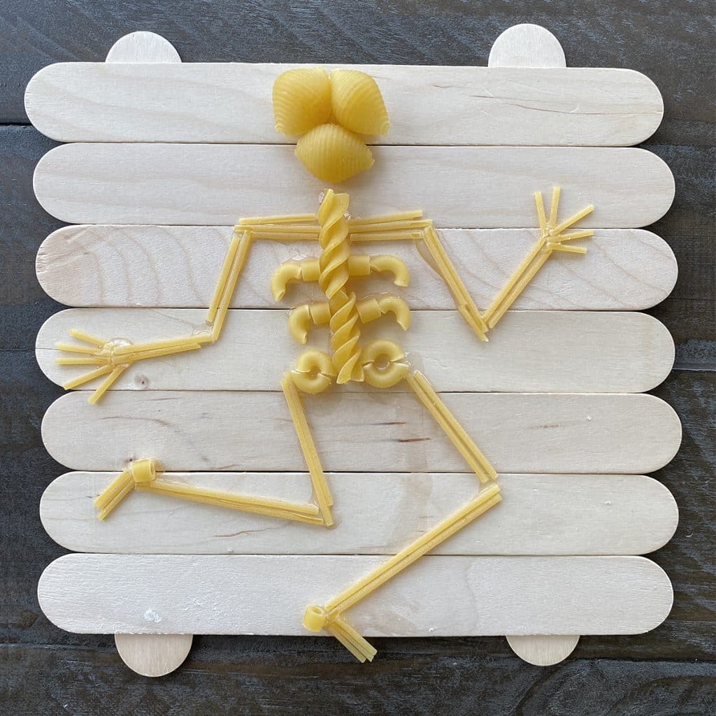 Pasta skeleton craft made with jumbo craft sticks