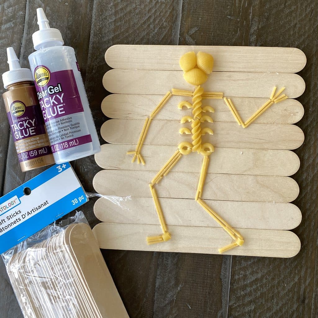 A pasta skeleton made with a board of jumbo popsicle sticks.
